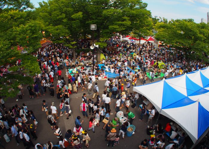 An overhead shot of the Thai Festival, showing crowds of people at Yoyogi Park.